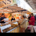 a busy street market in central paris near to the eiffel tower be9tan276521121