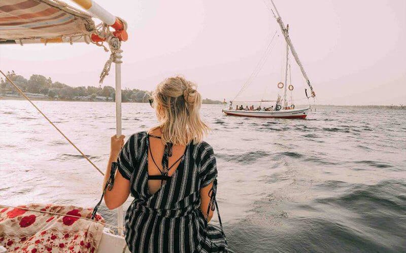 a tourist riding a felucca on the nile in aswan2065523209